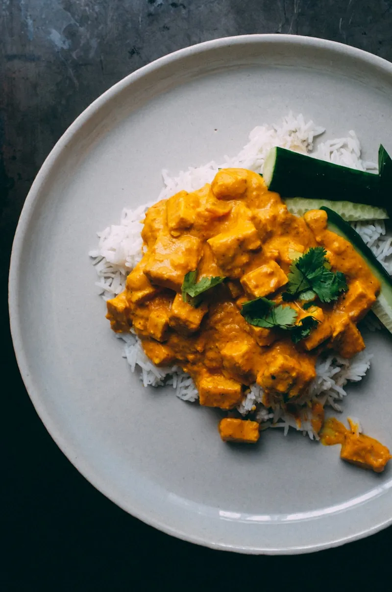 Butter chicken in creamy tomato gravy served over basmati rice at India Gate, St. John’s