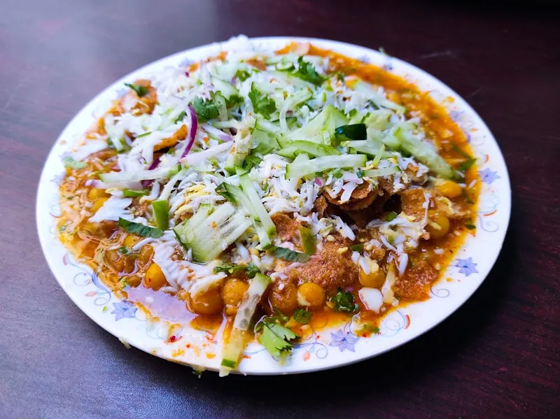 Plated Indian curry garnished with fresh herbs