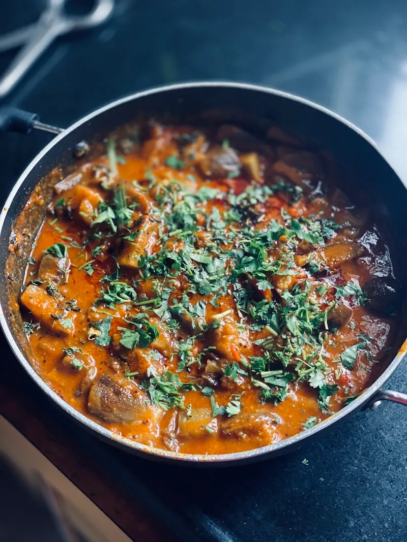 Curry simmering with whole Indian spices